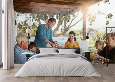 Happy family, eating and lunch with food outdoor on patio with conversation, bonding or healthy meal in summer. Parents, grandparents and kids at dining table in backyard of home with love or talking Wall mural