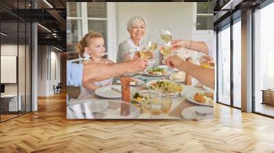 Happy family, lunch and cheers with wine glass in home patio for thanksgiving celebration. Parents, grandparents and children toast with drinks, food and generations at social gathering on holiday Wall mural