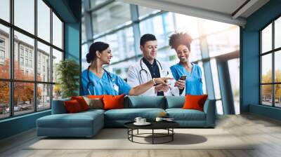 Healthcare, conversation and doctor with nurses, medicine and talking together at hospital. Medical, collaboration and smartphone with clinic, result and specialist for diagnosis and insurance Wall mural