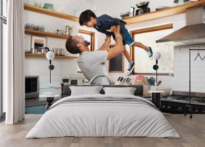 Home, father and child with lifting for playing, laughing and connection for bonding together as family. Happy people, son and dad in kitchen for breakfast, cooking and parent with kid for carrying Wall mural