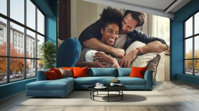 Home, happy and couple with hug on sofa for weekend romance, partnership and bonding together. Man, love and woman with affection in living room on couch for connection, support and trust in marriage Wall mural