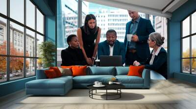 i need you all to see this presentation. shot of a team of businesspeople gathered around a laptop i Wall mural