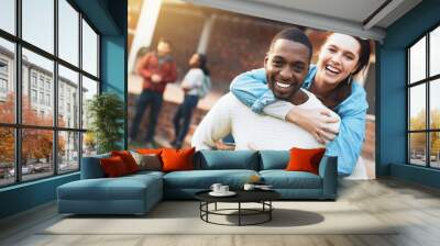 Interracial couple, portrait and students with hug for bonding, relationship or support at outdoor campus. Happy man, woman or gen z with smile in joy for piggyback, love or care together at college Wall mural