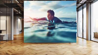 Kid, ocean and surfing in water for holiday, sports and wellness with board, blue sky and swimsuit. Boy, sea and swimming at beach as surfer for waves, fitness and summer workout while on vacation Wall mural