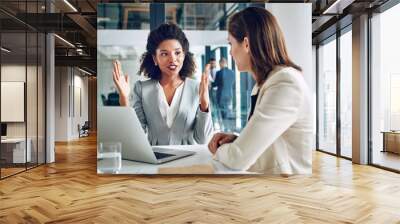 Laptop, talking and business women in office for discussion, meeting and consulting for online proposal. Corporate, financial advisor and people on computer for planning, website and feedback report Wall mural