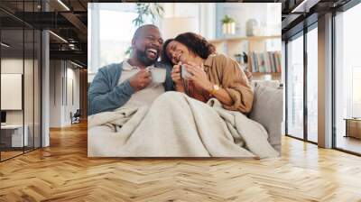 Laugh love and coffee with mature couple on sofa for bonding, marriage and romance. Happiness, calm and health with people drinking in living room of home for tea, communication and comfort together Wall mural