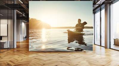 Man, kayak and boat on river trip for sports adventure or outdoor nature travel. Guy, paddling and sunrise workout for morning relaxation, rowing and fitness on lake or water on holiday or vacation Wall mural