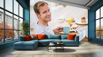 Man, tablet and breakfast with smile in portrait for current events or information at dining table. House, food and weekend with meal for nutrition with entertainment or relaxing at home in Sweden. Wall mural