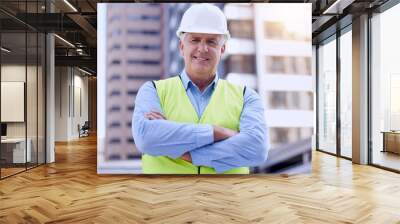 Mature, man and arms crossed with architect in city, portrait with confidence at construction site for engineering and labor. Maintenance, renovation and contractor outdoor for urban infrastructure Wall mural