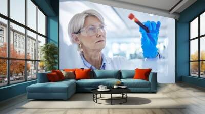 Mature scientist, medical research and test tube with blood sample in science laboratory for mpox vaccine. Female person, technician and virus in healthcare for chemistry, forensic or pharmaceutical Wall mural