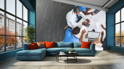 Medical team, meeting and technology in office from above, paperwork and healthcare in hospital. Men, women and specialist at table for brainstorming, consulting and financial planning in boardroom Wall mural