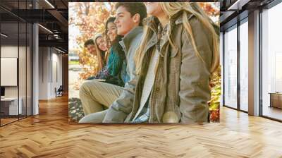 Nature, happy and group of teenagers travel on vacation, adventure or weekend trip together in Autumn. Smile, gen z and young friends on holiday sit in outdoor garden, park or field in New Zealand. Wall mural