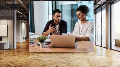 Office, laptop and colleagues with glasses, collaboration and together for working in project online. Workplace, woman and man with teamwork, photo editor and digital for planning or business Wall mural