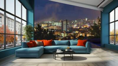 Outdoor, buildings and view of city at night with lights, skyscrapers and urban landscape for holiday or vacation in New York. Location, travel and dark with cityscape in evening downtown for journey Wall mural