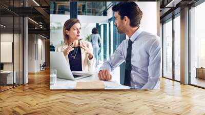 Planning, businessman and woman at laptop for advice, teamwork and consulting with financial advisor. Strategy, development and people in meeting for proposal ideas, review and discussion in office Wall mural