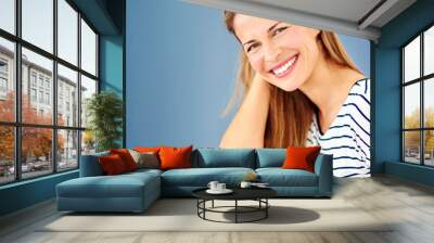 Portrait, beauty and woman with fashion, happiness and confidence on blue studio background. Face, person and model with stylish clothes, casual outfit and trendy with mockup space, joyful and smile Wall mural