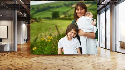 Portrait, family and children with mother outdoor for love, care and travel together. Mom, kids and siblings with baby in countryside for support, connection and people on summer holiday in Ireland Wall mural