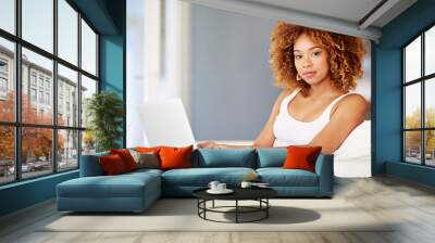 Portrait, laptop and technology with woman in living room for connection, networking and trending post. Chatbot portal, streaming platform and website with person at home for social media and online Wall mural