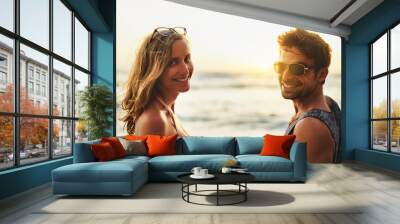 Portrait, man and woman with sunset in nature for beach, travel and summer vacation to island for love. Happy, couple and pride for holiday with sunshine, smile and people together for date in Bali Wall mural