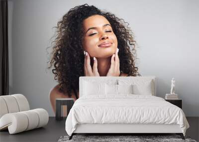 Portrait, woman and studio in relax for skincare, beauty and cosmetic on white background. Curly hair, cosmetology and facial treatment with collagen for model person, hands or texture for haircare Wall mural