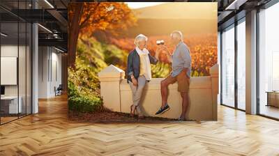 Senior couple, glasses and toast in outdoor for love, romance and relax in vineyard or nature. Elderly people, cheers and drink alcohol on vacation, marriage and calm celebration on anniversary Wall mural