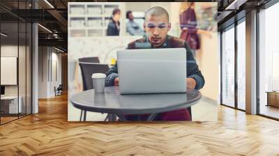 Small business, man and laptop at cafe as store manager on internet or website for online orders. Male person, entrepreneur and serious at coffee shop with email, schedule and employee timesheet Wall mural