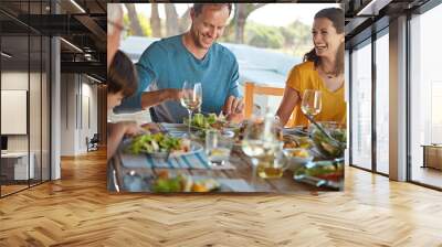 Smile, eating and family in backyard for food, celebration and happy bonding together at table. Children, parents and grandparents with laughing, drinks and lunch on patio for outdoor holiday fun Wall mural