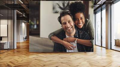 Smile, hug and couple with portrait on sofa for marriage bonding, partnership and romance together. Happy, man and woman with affection on couch at home for love, trust and connection on weekend Wall mural