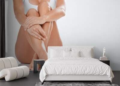 Studio, smooth and skin of legs, hands and hair removal for skincare, healthy and cosmetics in mockup. White background, relax and feet of person with treatment, lotion and soft with shine of body Wall mural