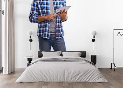 Studio shot of a handsome young man using a digital tablet Isolated on a PNG background. Wall mural