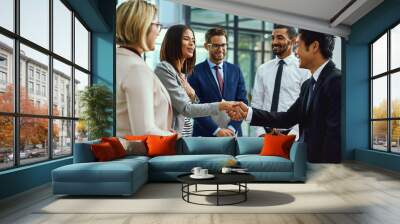 Team, business people and shaking hands for welcome, introduction or greeting in office. Handshake, smile and group with deal for collaboration, agreement or thank you for b2b partnership opportunity Wall mural