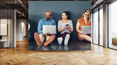 Technology, people and collaboration sitting on floor for teamwork, communication and diversity in office. Group, men and woman online for social media post, internet browsing or company research Wall mural