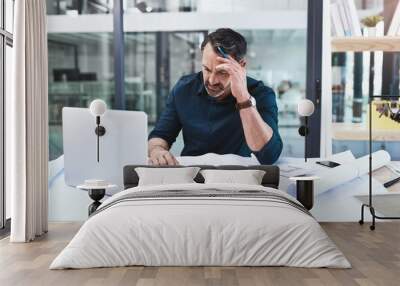 Tired, mature man and architect with headache, laptop and blueprints for stress planning building and design problem. Senior, male engineer and computer with documents for panic or stress at deadline Wall mural