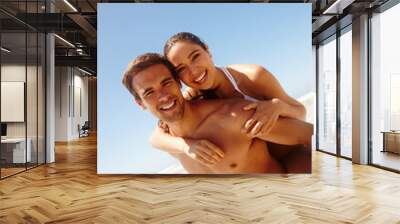 Vacation, portrait and couple piggy back at the beach with love, hug and support together on holiday in summer. Laugh, sea and happy with smile and bonding by water with travel in Miami with people Wall mural