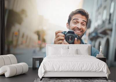 Vacation, portrait and man with camera, memory and travel with creativity, photographer and urban explore. Male person, journey and city journalist for photography, research and tourism adventure Wall mural