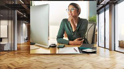 we might be able to use this. shot of a young businesswoman looking at her computer screen at work. Wall mural