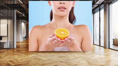 Woman, hands and orange for skincare in studio on white background and satisfied with routine. Natural, beauty and organic with confidence on portrait for skin treatment, ingredient and glow Wall mural