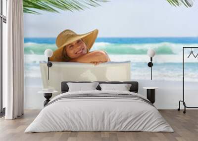 Woman, happy and travel at beach for relax, vacation and tanning in Bali with palm tree in summer. Girl, smile and portrait outdoor in morning for journey, wellness or tropical holiday with sun hat Wall mural