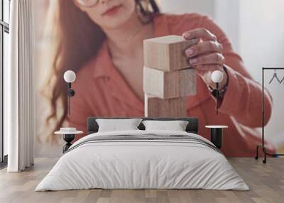 Woman, home and serious on desk with building blocks for problem solving, solution and educational. Female person, house and cubes with ideas, strategy and foundation for growth and creative Wall mural