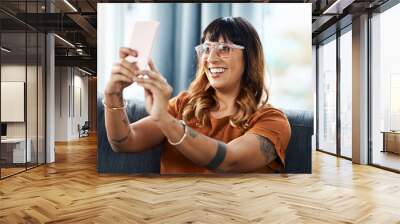 Woman, selfie and happy on sofa in home for content creation, memory or photography in living room. Person, influencer and smile with live streaming, vlog or profile picture for social media in house Wall mural