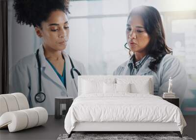 Women, doctors and explain on tablet in hospital for patient information, appointment and schedule. Database, medical and healthcare practitioner with technology for telehealth, service and medicine Wall mural