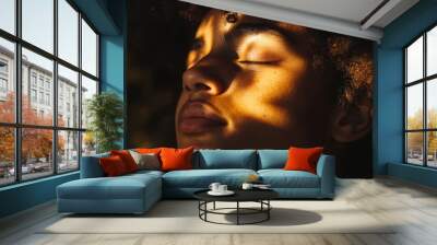 A woman with dark hair and a dark skin tone is looking at the camera Wall mural