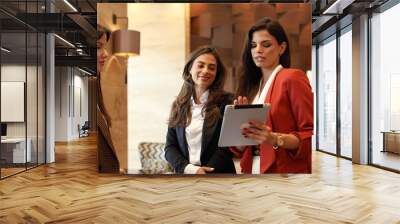 Three elegant businesswomen gathering to discuss business matters	 Wall mural