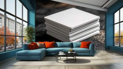 A stack of blank square coasters on a dark background Wall mural