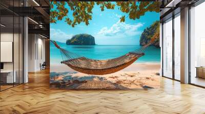 Wicker hammock on the beach, blue water and sky Wall mural