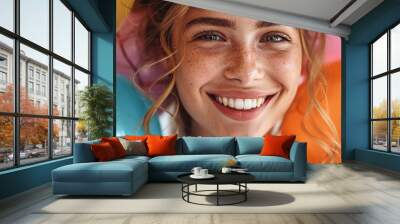 A woman with a cheerful smile, holding a bouquet of colorful balloons and looking up with eyes full of happiness against a plain white background. Wall mural