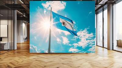 El Salvador flag fluttering against a bright, blue sky Wall mural