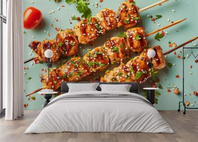  Chicken fillet yakitori on a teal green table background. Appetising shish kebab of fried chicken on skewers with honey glaze, herbs and sesame seeds. Epicure food banner with copy space. Wall mural