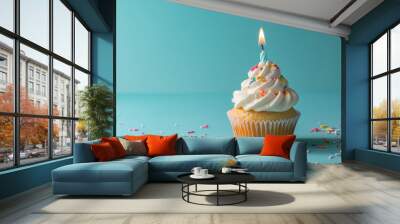 Birthday cupcake with candle on light blue table against blurred blue background. Party banner with copy space for festive celebrations and happy occasions. Wall mural