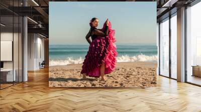 Young Spanish woman dancing flamenco on the beach Wall mural